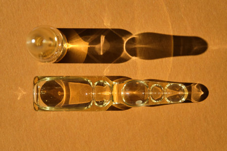 Glass ampoules on a beige orange background.の写真素材