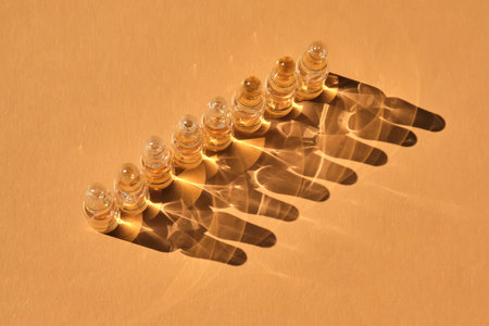 Glass ampoules on a beige orange background.の写真素材
