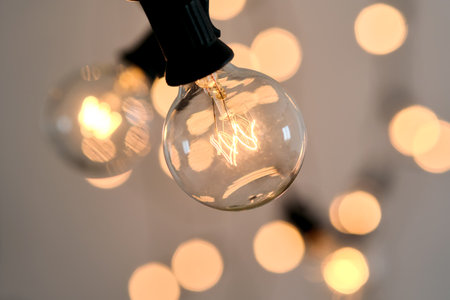 Incandescent light bulb with christmas round bokeh.