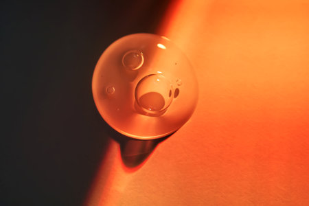 A drop of sunscreen body gel in the orange sunset light.の写真素材