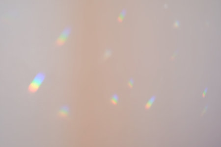 Rainbow highlights on a white wall.