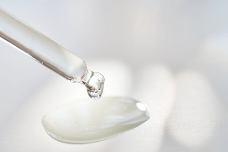A transparent pipette of serum under the morning sun.の写真素材