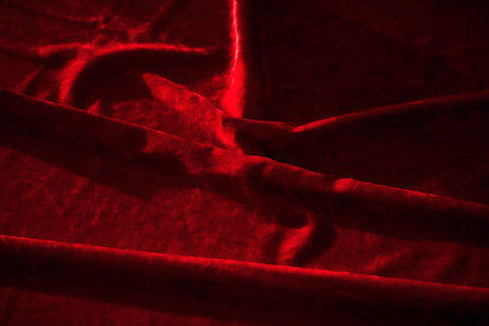 Abstract background made of red velvet fabric.の写真素材