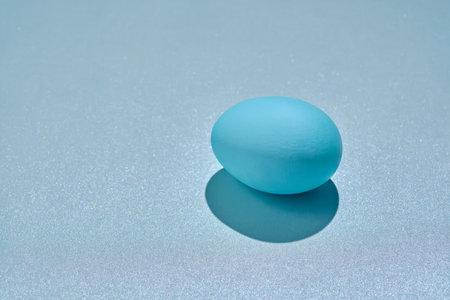 Blue Easter egg on a blue background.の写真素材