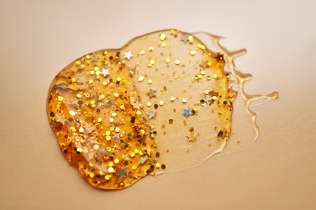 Cosmetic gel with glitter on a beige background.の写真素材