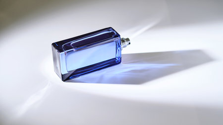 Perfume spray in a blue bottle on a white background.の写真素材