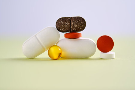 Pills, vitamins and dietary supplements on a green background.の写真素材