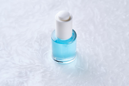 Bottles of serum with a dropper in liquid with pearl tints.の写真素材