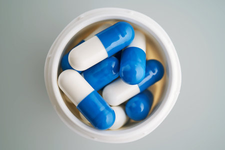 Blue and white capsules in a jar close-up.