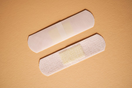Adhesive plaster on a beige background on both sides.の写真素材