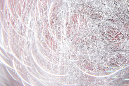 Light grey and white tinsel background with bokeh for Christmas.