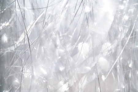 Light grey and white tinsel background with bokeh for Christmas.の写真素材