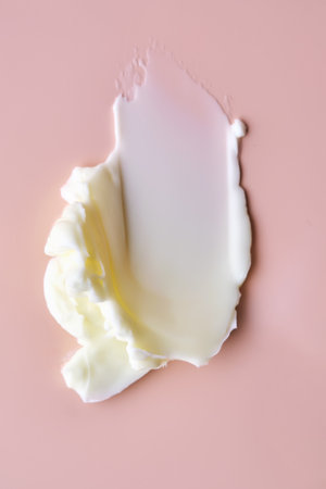 Texture of cosmetic butter on a pink background. Showcasing a thick and nourishing texture.の写真素材