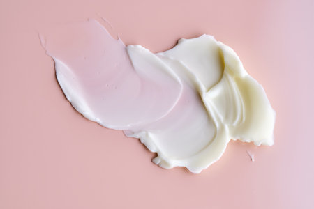 Texture of cosmetic butter on a pink background. Showcasing a thick and nourishing texture.の写真素材