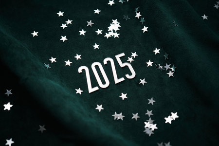 New Years background made of green velvet with silver stars and the number of the year 2025.