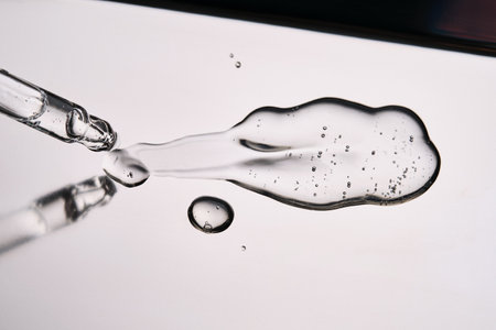 Pipette with cosmetic gel or serum close-up.