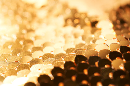 Abstract festive gold background made of sequins.の写真素材