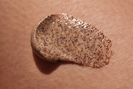 Coffee cream scrub on human skin close-up.の写真素材