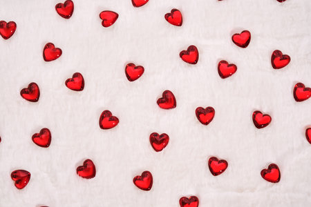 Abstract textured background with hearts on a white plush background.