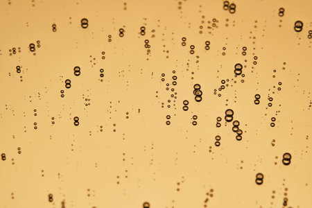 The beautiful texture of the serum on a gold background that takes up most of the photo.の写真素材