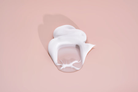 The texture of white cream on a pink background.の写真素材