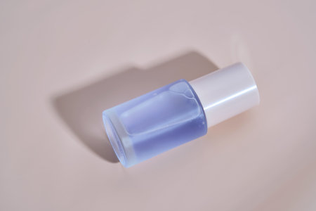 A bottle of blue serum on a delicate beige background.の写真素材