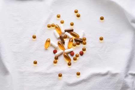 Vitamins and supplements on a white cotton background.の写真素材