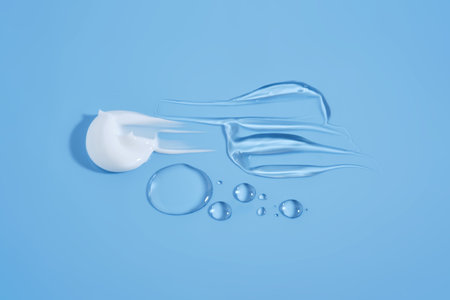 Drops and smears of cosmetic products on a blue background.の写真素材