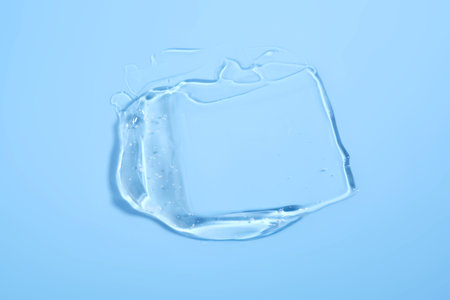 The texture of a cosmetic gel on a blue background.の写真素材