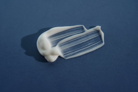 White moisturizer on blue background.の写真素材