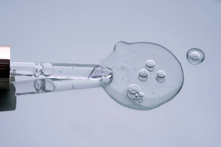 Pipette with serum on a blue background. Product texture.の写真素材