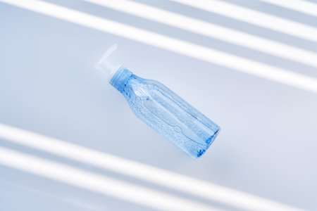 Tube of gel on a white background with stripes of shadows.