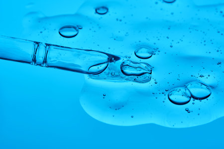 Hydrolyzed sponge serum with a pipette on a blue background.