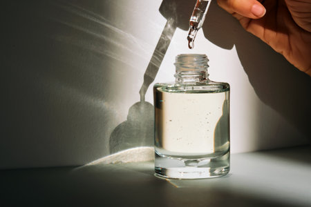 The facial serum drips into a bottle. Lifestyle.