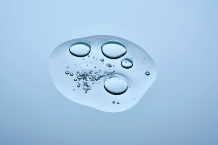 A drop of cosmetic beauty gel texture on a blue background.