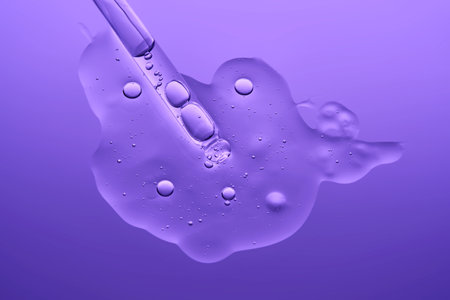 The texture of a serum with microneedles and a cosmetic pipette on a lilac background.の写真素材