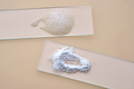 Enzyme powder before and after foaming on a beige background. Textures.の写真素材