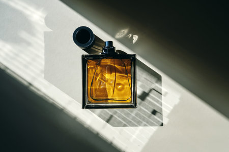 Perfume bottle in the rays of bright sun with beautiful highlights.の写真素材