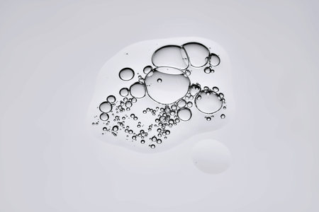 A beautiful drop of serum on a gray background.の写真素材