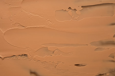 The texture of foundation on a beige background.の写真素材