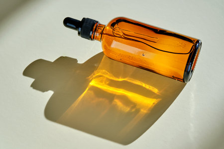 Face serum in a dark bottle in the sunlight.の写真素材