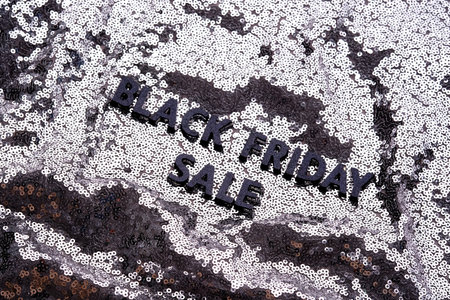 The inscription BLACK FRIDAY SALE on a shining background of silver sequins.の写真素材