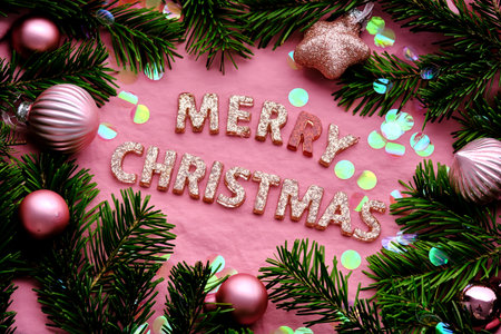 Merry Christmas pink background. Inscription in Christmas decoration.の写真素材