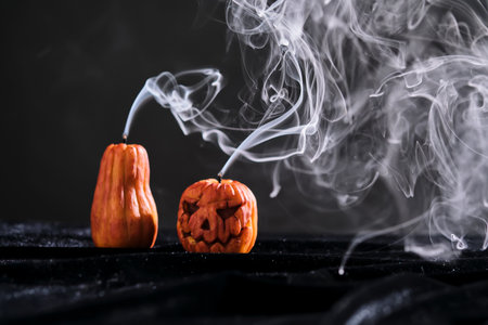 Halloween-style candles on a dark background. Festive decor.の写真素材