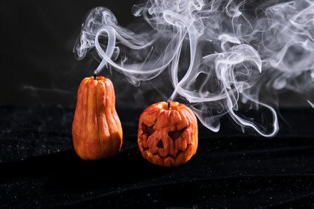 Halloween-style candles on a dark background. Festive decor.の写真素材