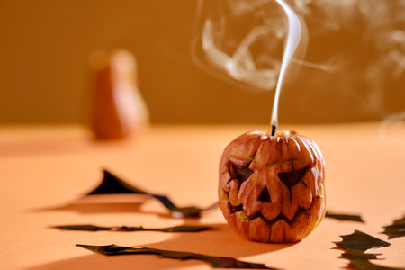 Halloween-style candles on a orange background. Festive decor.の写真素材