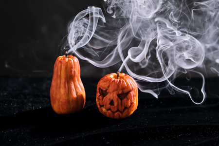 Halloween-style candles on a dark background. Festive decor.の写真素材