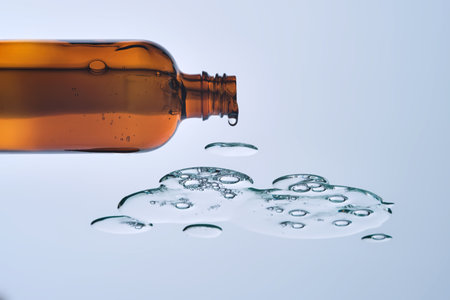 A bottle of serum and a drop of texture. View from below.の写真素材