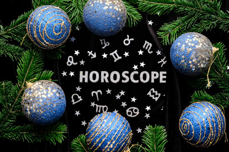 Abstract background with the inscription Horoscope on a black velvet background with fir branches.の写真素材