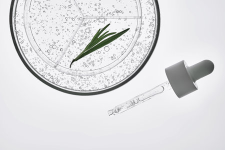 The texture of rosemary serum in a petri dish on a white background.